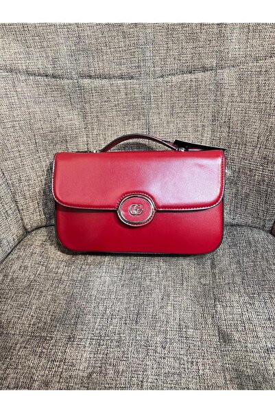 Generic حقيبة كتف مستطيلة حمراء زاهية، بتصميم كلاسيكي ومقبض علوي، مزينة بحلية معدنية فضية لامعة. قطعة