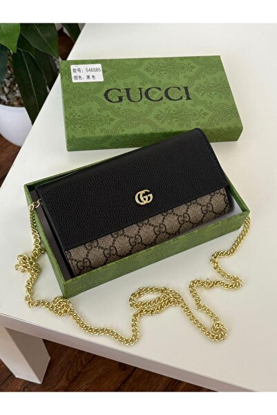 Generic Women's wallet with a black leather cover, decorative fabric section, and gold chain.