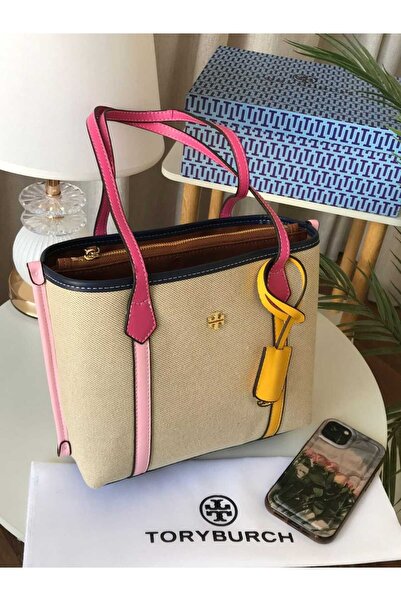 Generic A small beige canvas handbag with pink handles, featuring a decorative yellow ring.