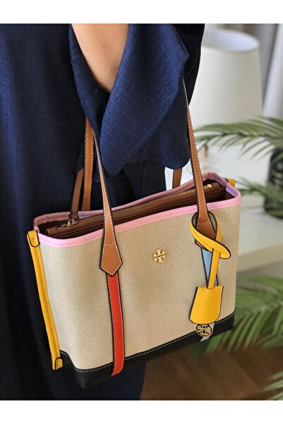 Generic A stylish shoulder bag made of light-colored fabric, decorated with multi-colored leather straps.