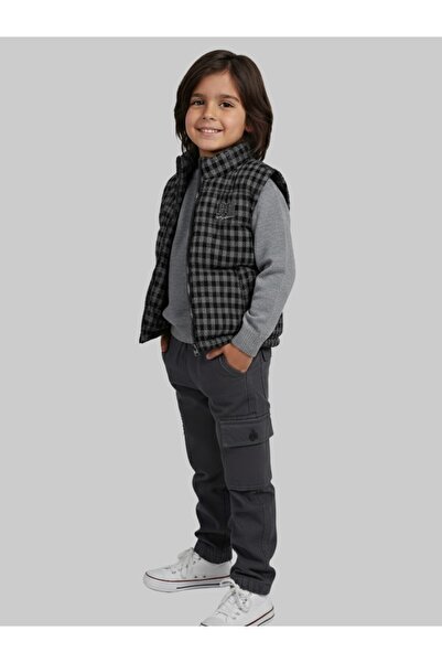 First A stylish boys' suit that combines comfort and elegance, consisting of a modern jacket and gray trousers.