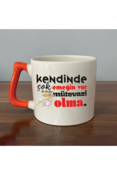 Kırtasiye Ofisi كوب هدية تحفيزي برتقالي اللون مع مقبض، يحمل عبارة 'إنه يمتلك ...