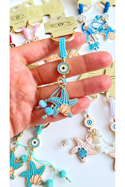 Cassime Breloc cu ochi de stea de mare albastru deschis, placat cu aur