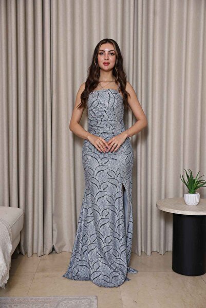 molan fashion A sophisticated silver evening gown with a fitted design that hugs and sculpts the waist smoothly.