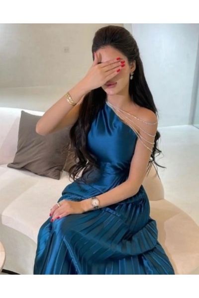 Masha Mashaeil ~ A soft, petrol-colored dress with crystal chains on the shoulder in a luxurious, modern design