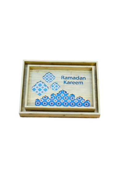 WOOD A set of two wooden serving trays with a glass base and decorative Ramadan-themed engravings.