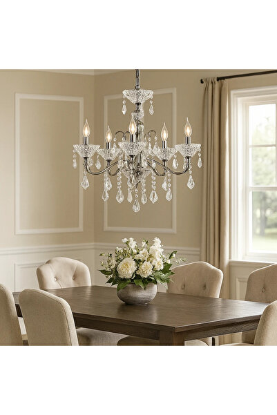 HAMER A classic chandelier provides a warm light that complements the shiny silver furniture.