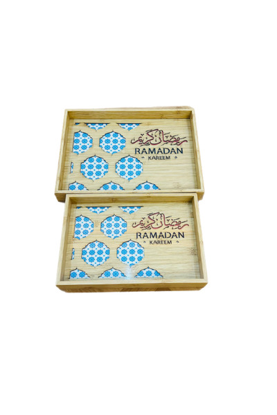 WOOD A set of two wooden serving trays with a glass base and decorative Ramadan-themed engravings.