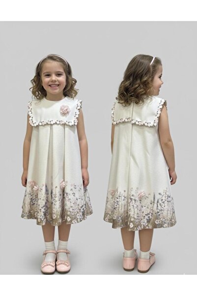 gmax A girl's dress with an elegant touch, adorned with embroidery and raised flowers.