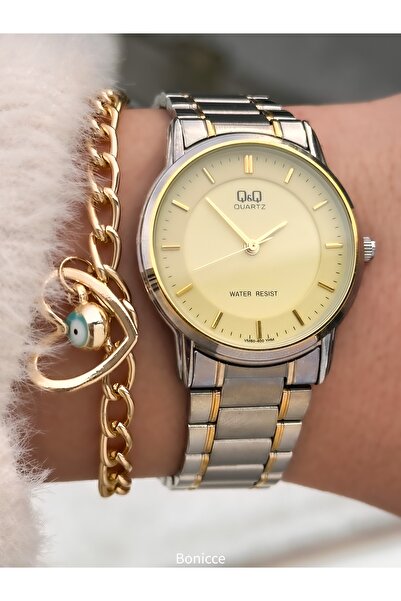 Q&Q ساعة يد نسائية من ماركة ستيل كوردون، مقاومة للماء، لون ذهبي، مع ضمان لمدة...