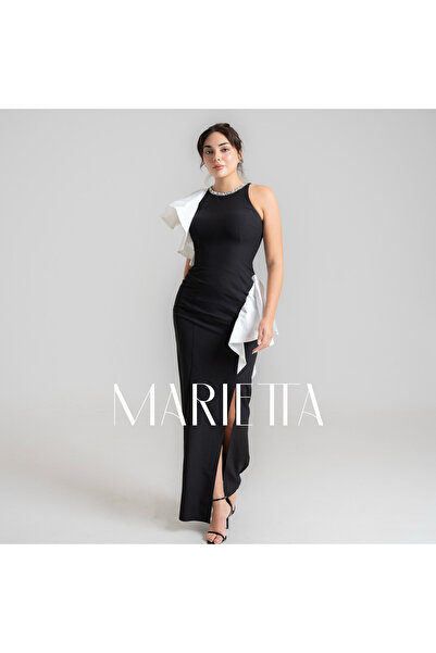 Thnyiah A soft black dress with beading on the neck.
