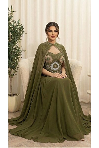 BROOKLYN STYLE A luxurious olive-green evening gown with a regal cape design and exquisite hand embroidery on the bodice.