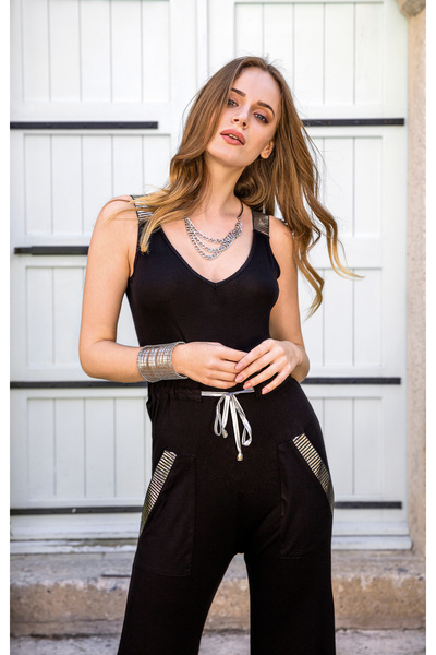 Stylish A practical and stylish black jumpsuit with a wide neckline and a mod...