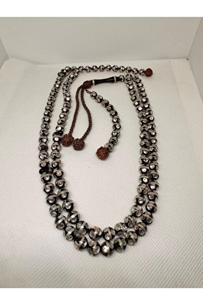 Generic A rosary made of coconut inlaid with silver and crystal beads.