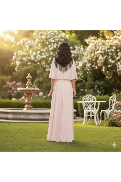FULLJOY An elegant long dress in a light, flowing fabric with a distinctive collar and a touch of luxurious fringe.