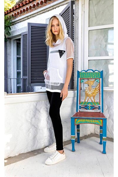 Stylish A stylish three-piece sportswear set with a sheer mesh top for a soph...