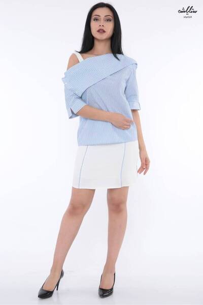 Stylish An elegant tailored suit featuring a white and blue striped blouse wi...