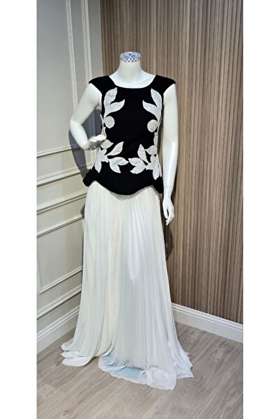 ainaqat aljawhara Black evening dress with white embroidery on the sides of t...