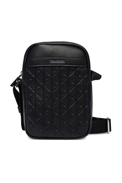 Calvin Klein Borseta EMBLEM AOP EMBOSS SLIM REPORTER Unisex