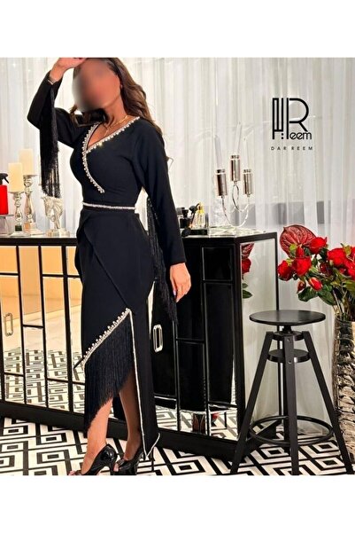 RDM A luxurious black evening dress with pearl embroidery and silk fringe.