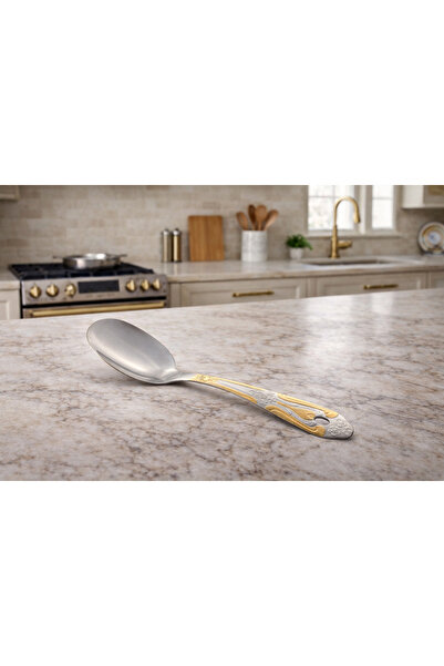 Dania A stainless steel serving spoon with a gold embellishment… luxury that ...