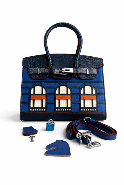 Evo A luxurious handbag with a distinctive architectural design, crafted from...