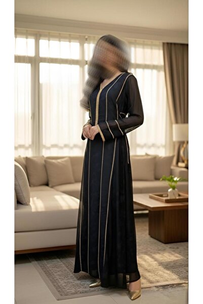 ISHRAQAT AL-AMAL A long dress with long, slightly wide sleeves, decorated wit...