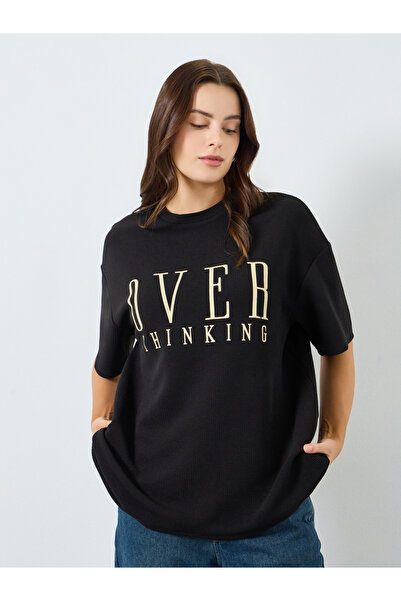 Styli Women Black Oversized Slogan Print T-Shirt