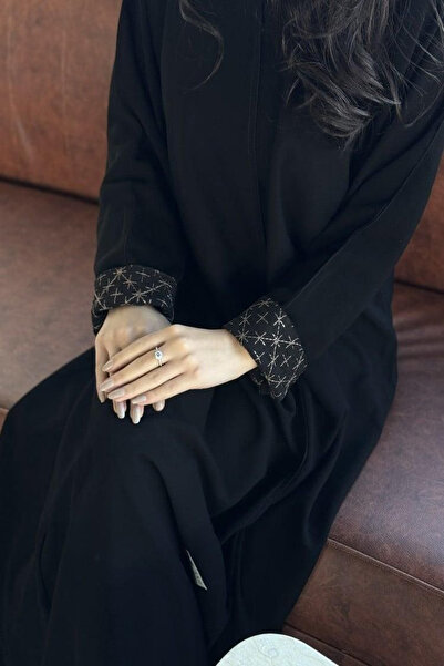 Elena Black star abaya with a quarter-circle cut and a hidden snap closure, w...