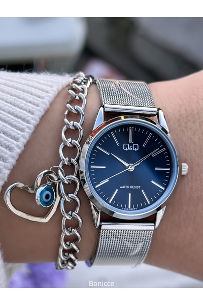 Q&Q حزام فولاذي، مقاوم للماء. ساعة يد نسائية فضية اللون + سوار