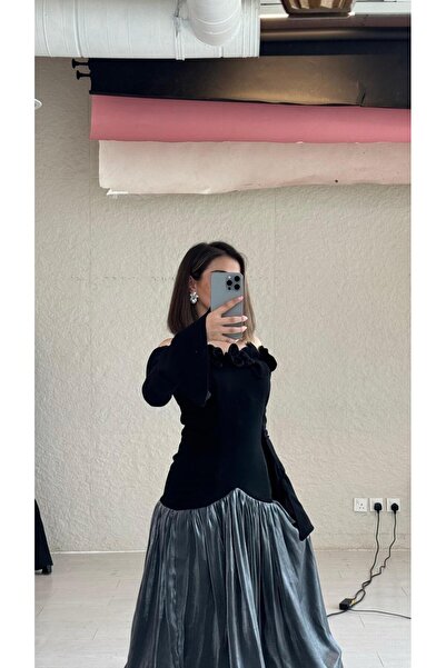 DUBAİ An elegant black dress with a sophisticated design that highlights the ...