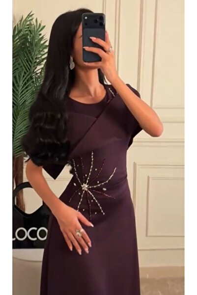 NALA FASHION A royal purple evening dress with an off-the-shoulder design and...