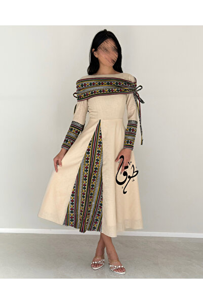 toog A modest dress with traditional embroidery and an elegant wide cut