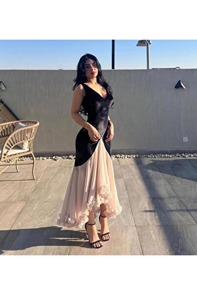 Ta Prince An elegant evening dress with a modern design that highlights the b...