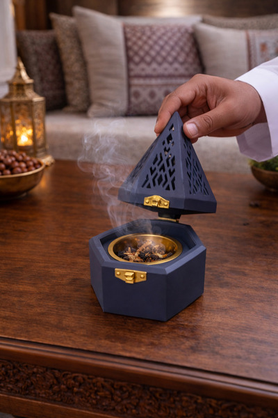Generic A luxurious pyramid-shaped incense burner in navy blue – an elegant a...