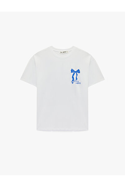 Koton تي شيرت قطني بأكمام قصيرة وياقة دائرية وطبعة فيونكة من الخلف