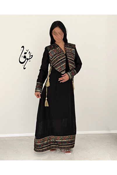 toog A long black dress with a classic cut and traditional embroidery, with a...