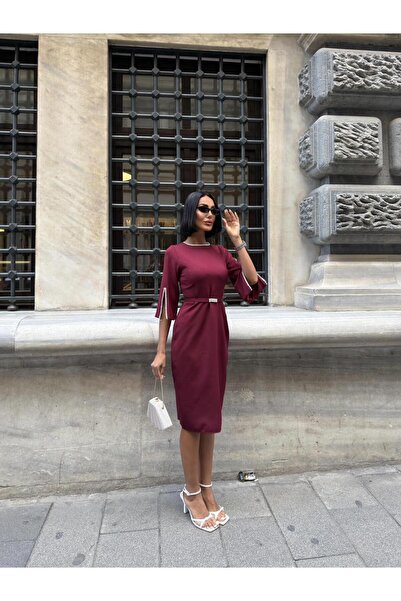 Miss Janell A soft and elegant burgundy dress with mid-length sleeves, adorne...
