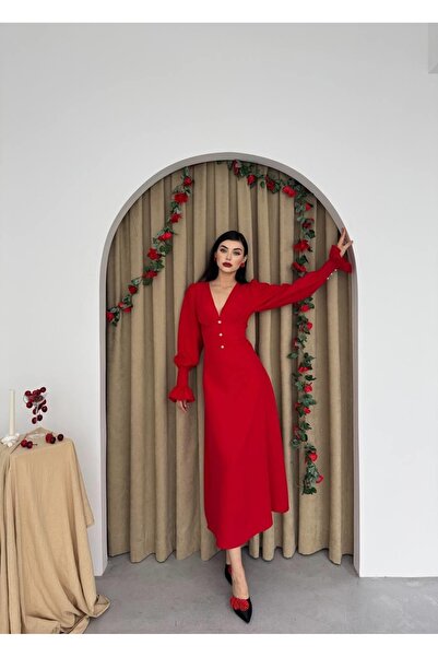 Etika Soft red dress with long sleeves, elegantly adorned with buttons, featu...
