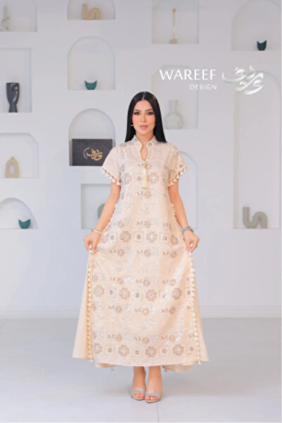 WAREEF FASHION A soft ivory-colored jalabiya with elegant floral embroidery a...