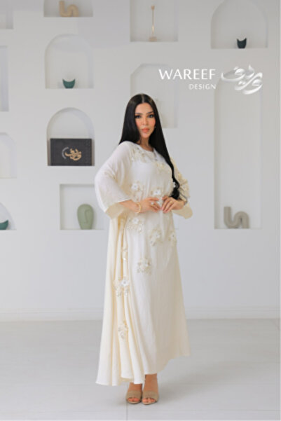 WAREEF FASHION A soft, cream-colored jalabiya with elegant pink embroidery an...