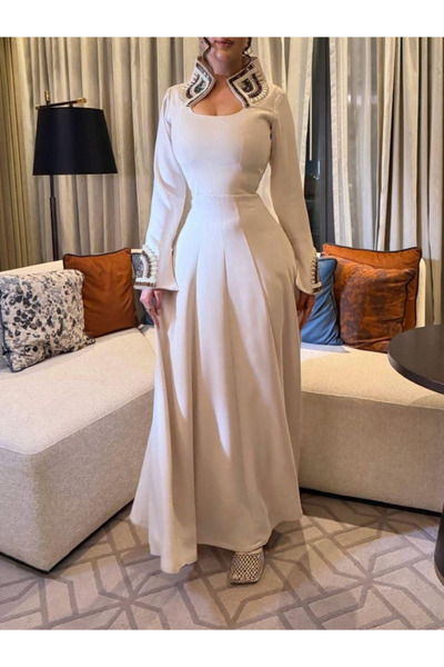 Almorjan A luxurious, beaded evening dress with a high neck and long sleeves,...