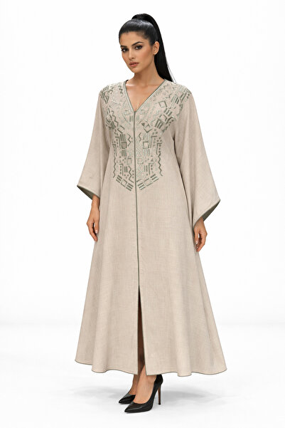 Al Afnan Boutique A stylish and distinctive beige jalabiya adorned with embro...