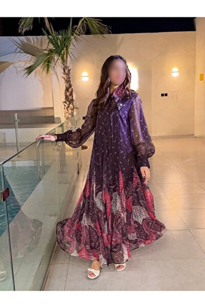 REVE A wide purple chiffon patterned dress with puffed sleeves and an elegant...