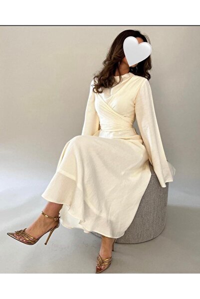 Cutie A soft evening dress with a wrap design and defined waist details.