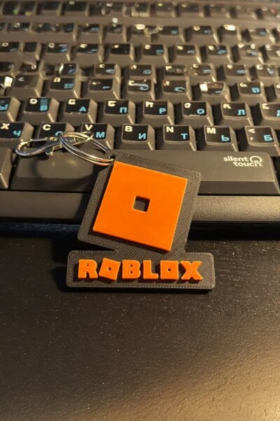 Lades سلسلة مفاتيح بشعار روبلوكس باللون البرتقالي