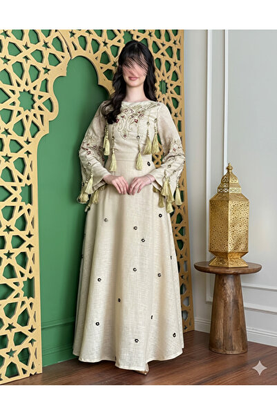 Azyaa Al-Amira A delicate evening dress with heritage embroidery and gold fri...