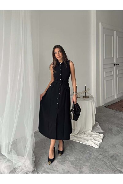 MISS JANEL A soft and elegant women's dress adorned with dangling button deta...