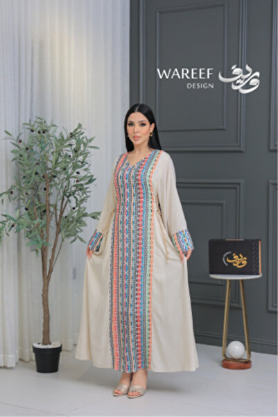 WAREEF FASHION A soft beige jalabiya adorned with multicolored geometric patt...