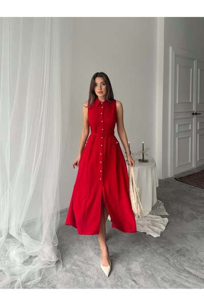Miss Janell A long, soft, and elegant dress adorned with dangling button deta...